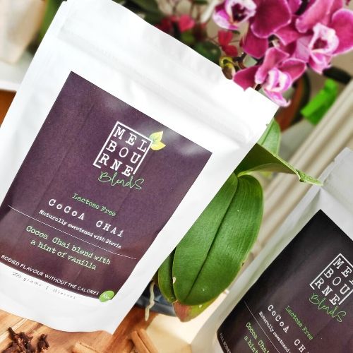 Lactose Free Cocoa Chai Latte packed in 200gr white bag with brown label position on timber board