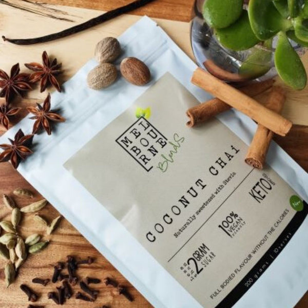 Coconut Chai Latte packed in 200gr white bag with cream label position on timber board Keto approved, 100% Vegan, less than 2 grams of sugar per serve