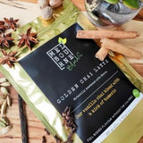 Turmeric Chai Latte packed in 200gr gold bag with black label position on timber board decorated with spices and flower