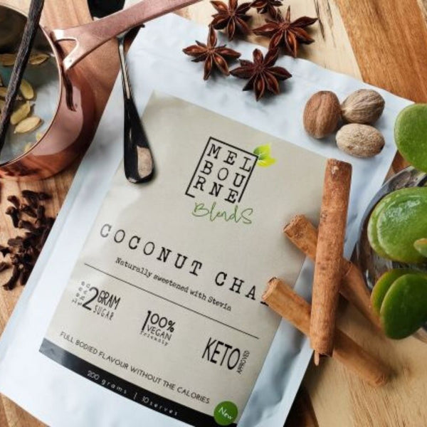 Coconut Chai Latte packed in 200gr white bag with cream label position on timber board Keto approved, 100% Vegan, less than 2 grams of sugar per serve