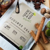 Coconut Chai Latte packed in 200gr white bag with cream label position on timber board Keto approved, 100% Vegan, less than 2 grams of sugar per serve